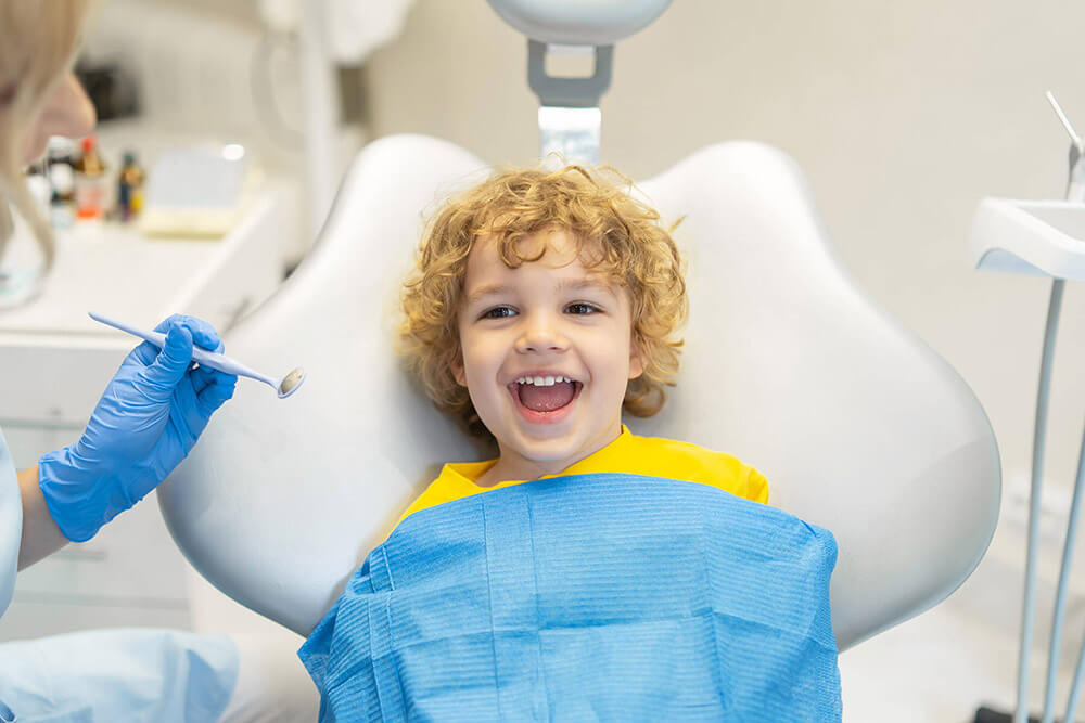 kid smiling in dental chair
